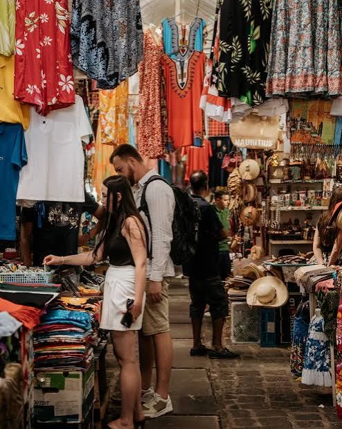 Shoppers browsing clothes and souvenirs at a craft market in Mauritius